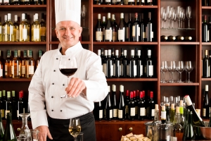 Chef cook smiling serve wine glass restaurant